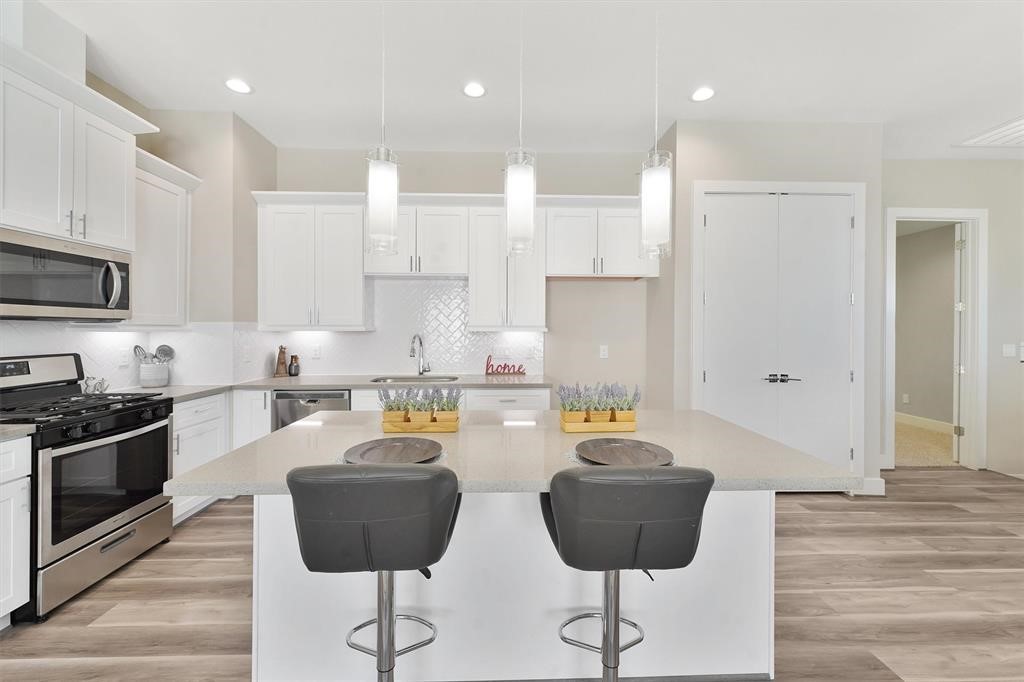 2504 West Tidwell Road, Unit G Houston, TX 77091 - Photo 14 of 30 a kitchen with stainless steel appliances granite countertop a stove a refrigerator a sink a counter top space and cabinets