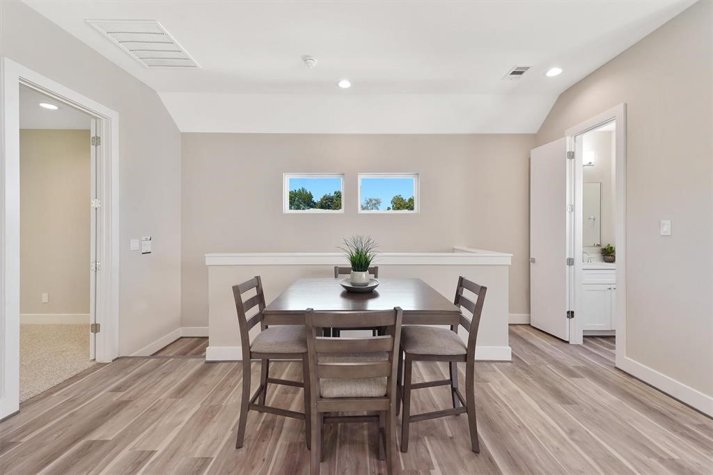 2504 West Tidwell Road, Unit G Houston, TX 77091 - Photo 16 of 30 a view of a dining room with furniture and wooden floor