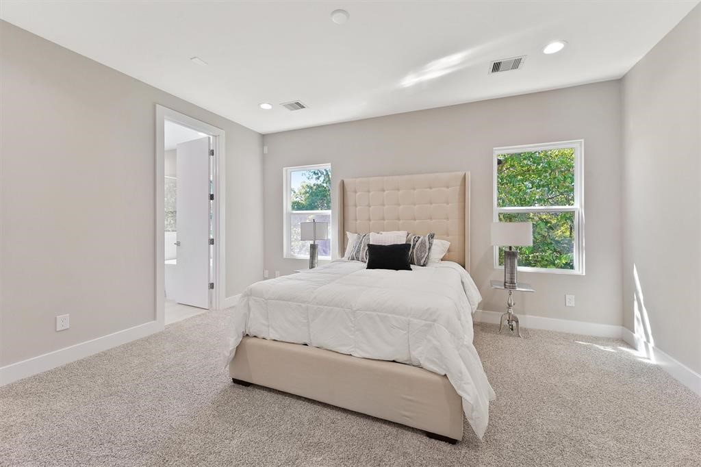 2504 West Tidwell Road, Unit G Houston, TX 77091 - Photo 20 of 30 a spacious bedroom with a bed and a window