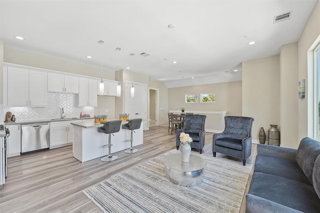 2504 West Tidwell Road, Unit G Houston, TX 77091 - Photo 2 of 30 a living room with lots of furniture and kitchen view