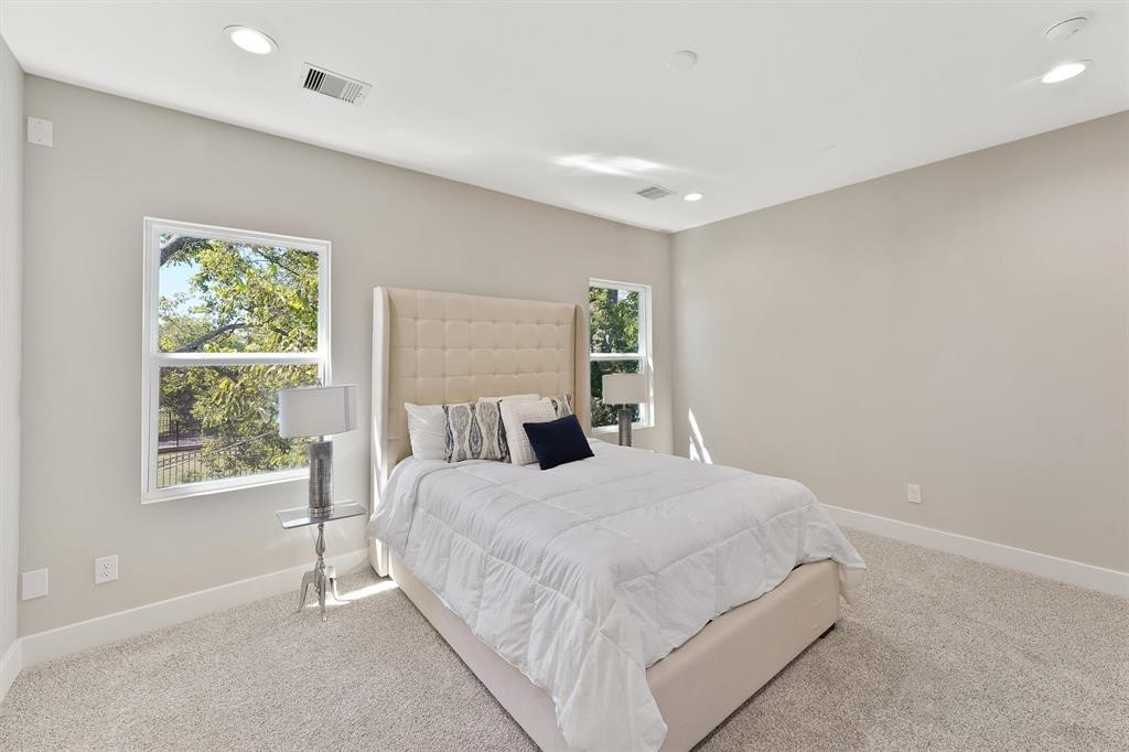 2504 West Tidwell Road, Unit G Houston, TX 77091 - Photo 21 of 30 a bedroom with a large bed and a window