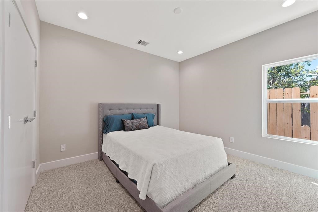 2504 West Tidwell Road, Unit G Houston, TX 77091 - Photo 26 of 30 a bedroom with a bed and window