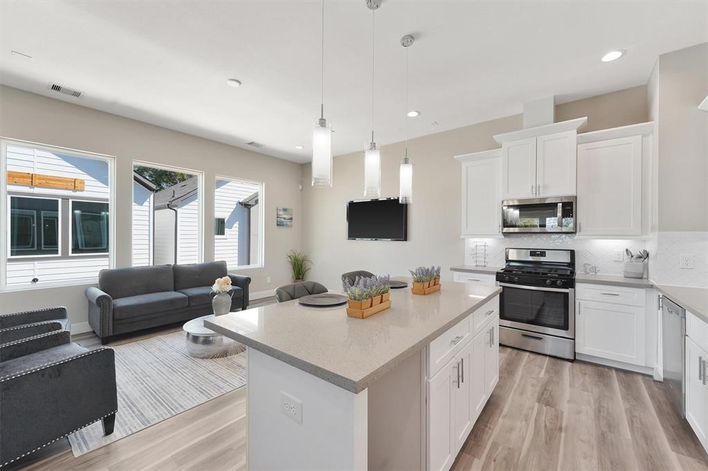 2504 West Tidwell Road, Unit G Houston, TX 77091 - Photo 6 of 30 a kitchen with stainless steel appliances granite countertop a sink stove and refrigerator