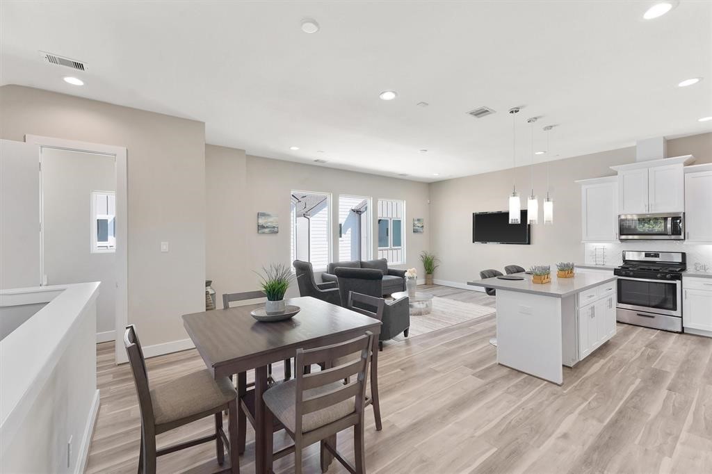 2504 West Tidwell Road, Unit G Houston, TX 77091 - Photo 7 of 30 a view of a dining room with furniture and wooden floor
