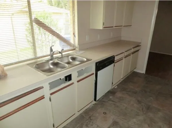 a kitchen with a sink stove and cabinets