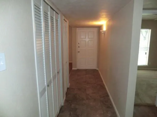 a view of a hallway with wooden floor