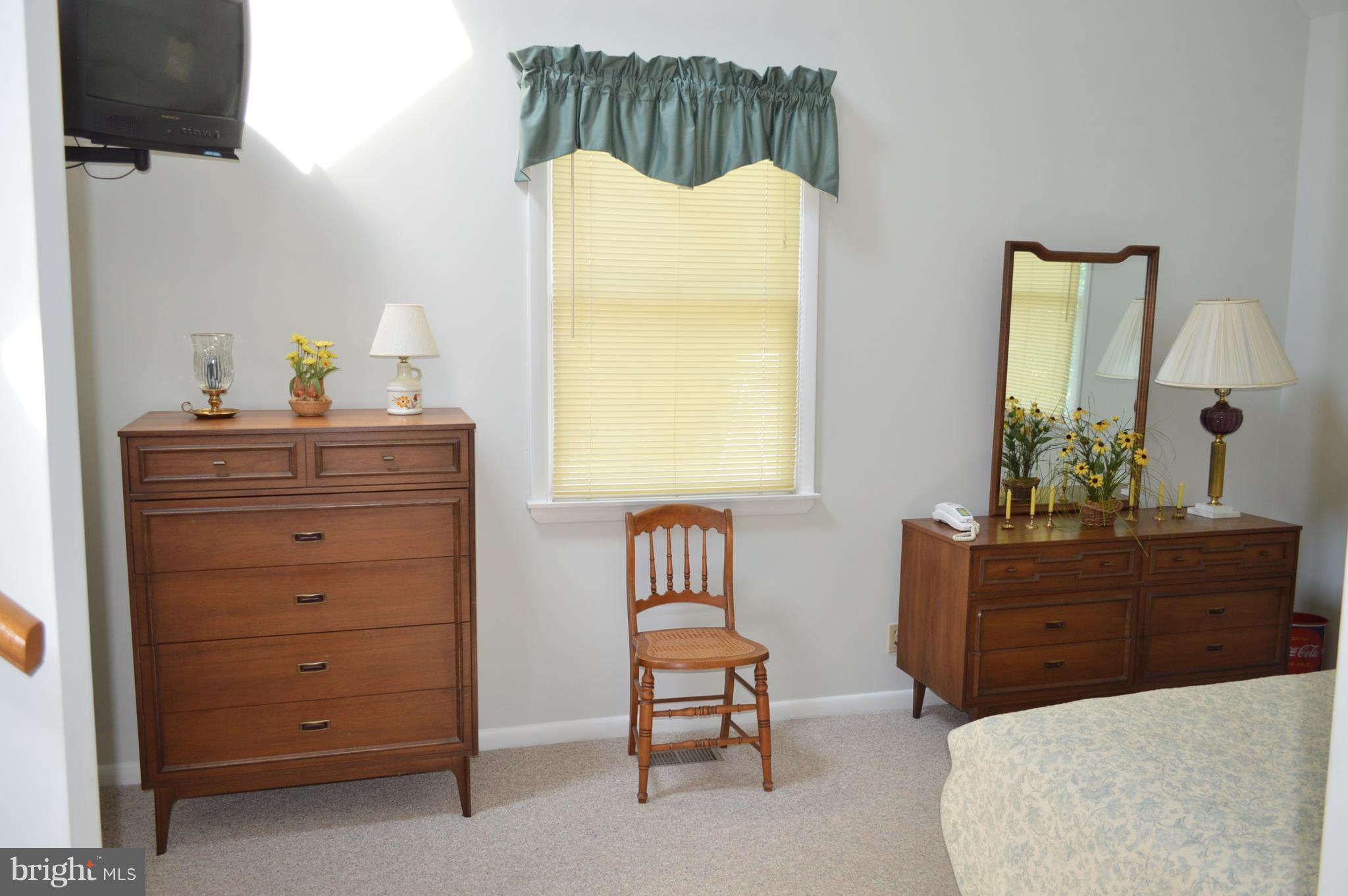 2124 Poplar Road Baltimore, MD 21221 - Photo 12 of 29 a bedroom with a bed and a mirror on dresser