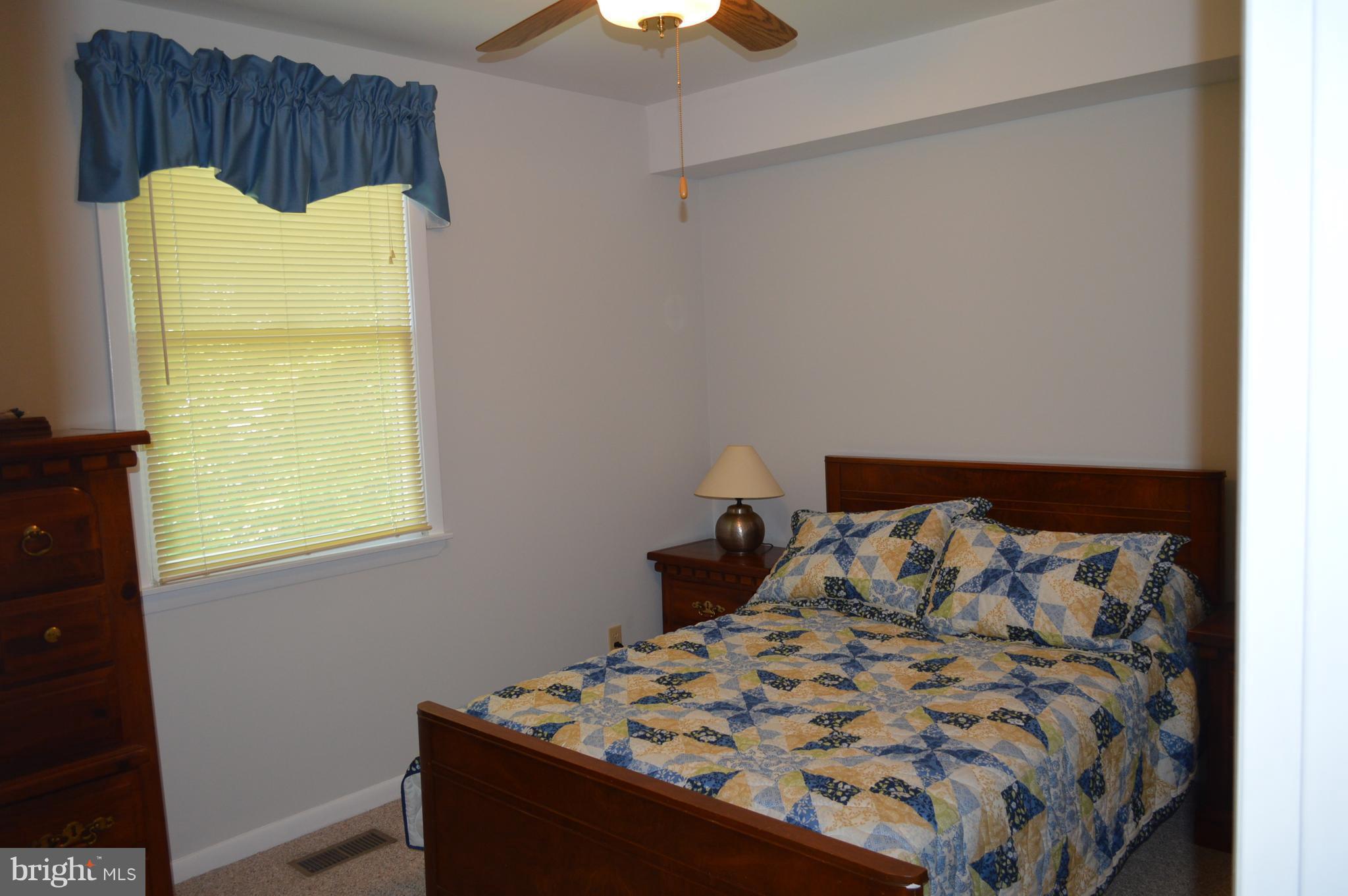 2124 Poplar Road Baltimore, MD 21221 - Photo 14 of 29 a bed sitting in a bedroom next to a window