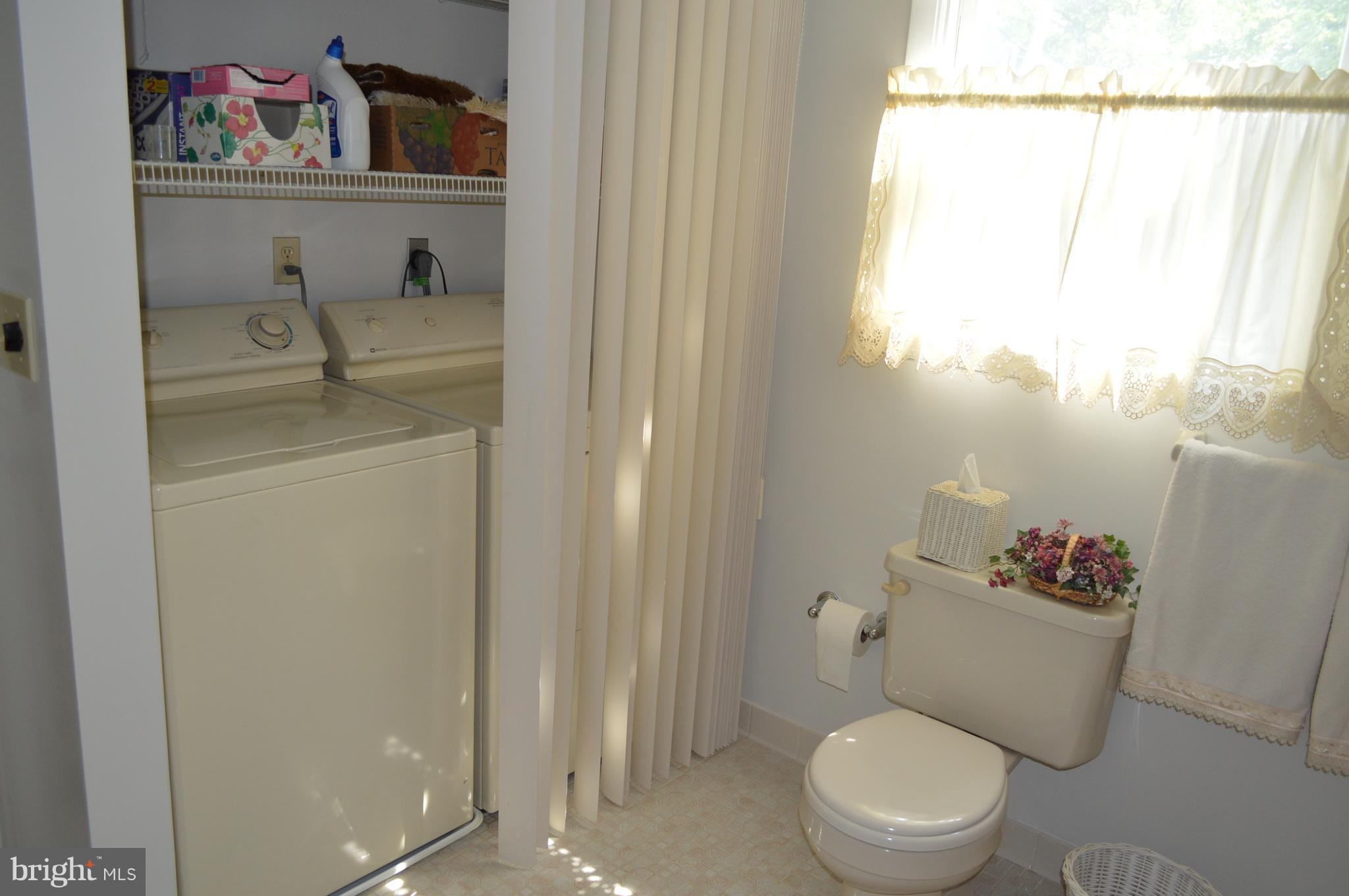 2124 Poplar Road Baltimore, MD 21221 - Photo 16 of 29 a bathroom with a toilet sink vanity and mirror