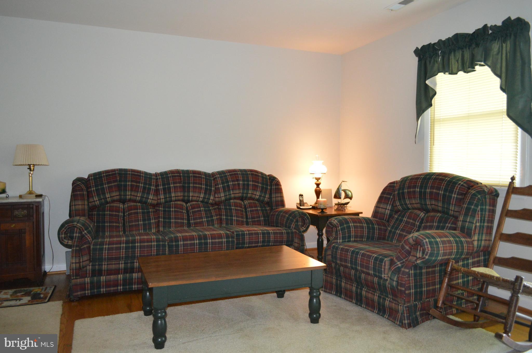 2124 Poplar Road Baltimore, MD 21221 - Photo 19 of 29 a living room with furniture a table and wooden floor