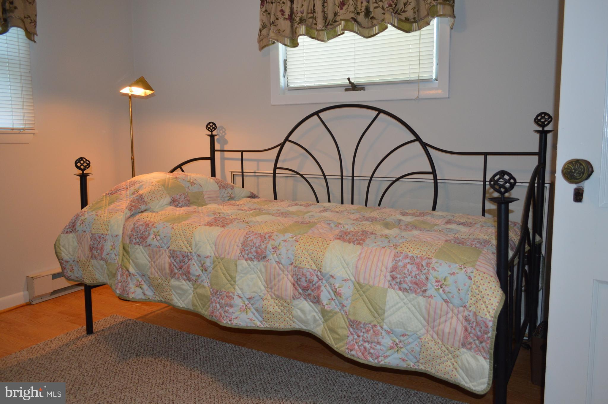 2124 Poplar Road Baltimore, MD 21221 - Photo 23 of 29 a bedroom with a bed and a painting on the wall