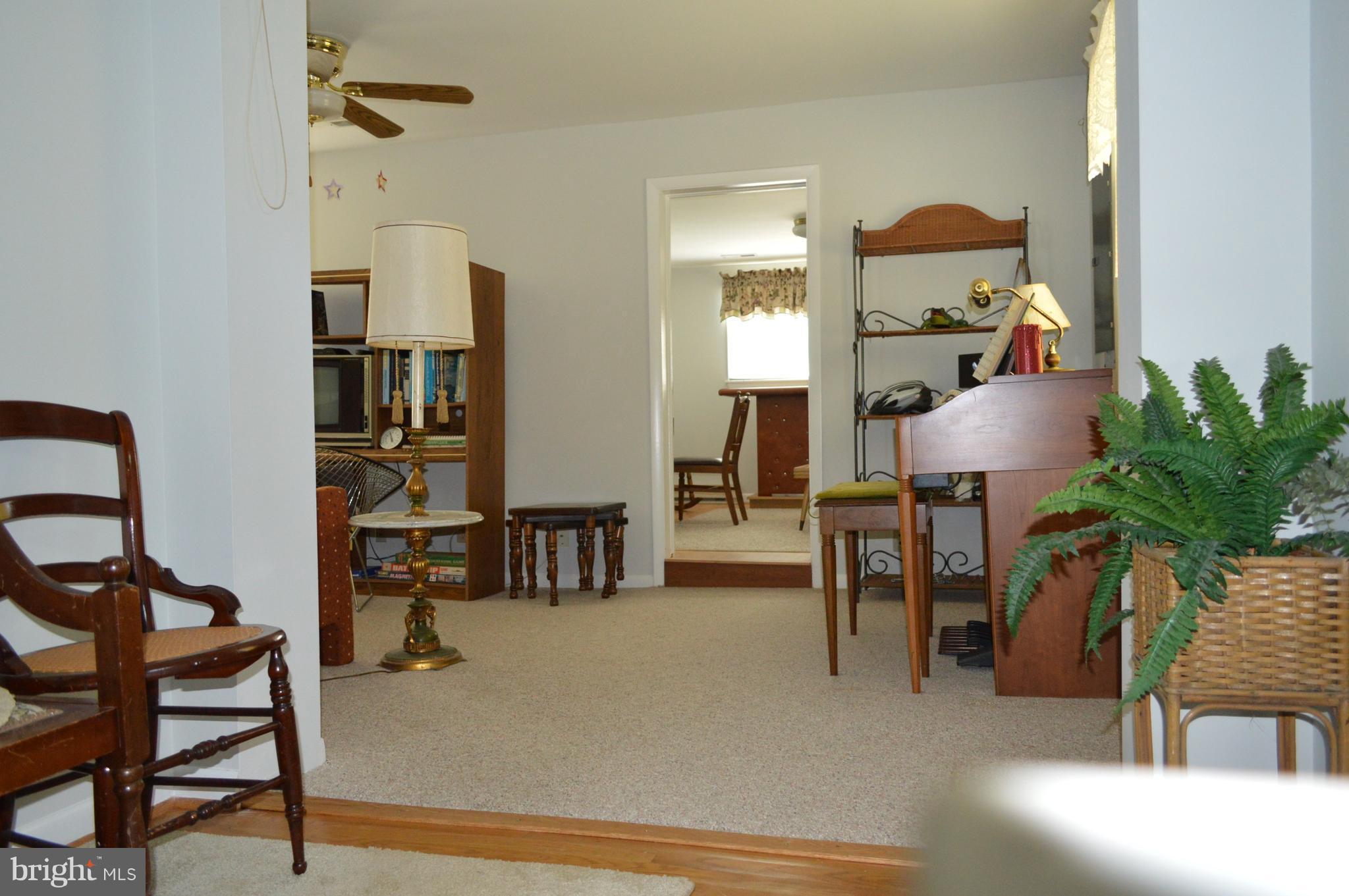 2124 Poplar Road Baltimore, MD 21221 - Photo 29 of 29 a living room with furniture a dining table and a potted plant