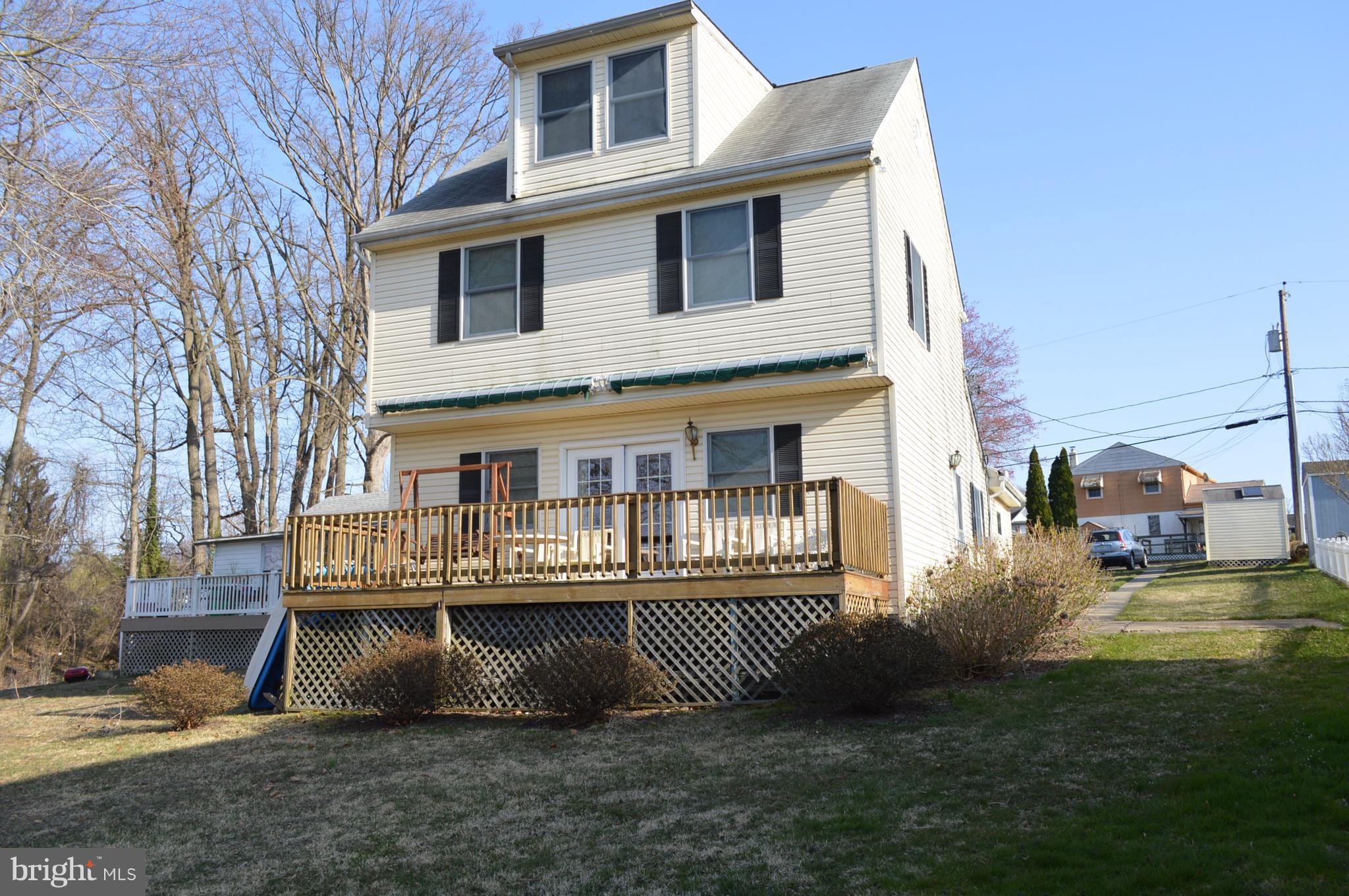 2124 Poplar Road Baltimore, MD 21221 - Photo 5 of 29 a front view of a house with a yard and trees