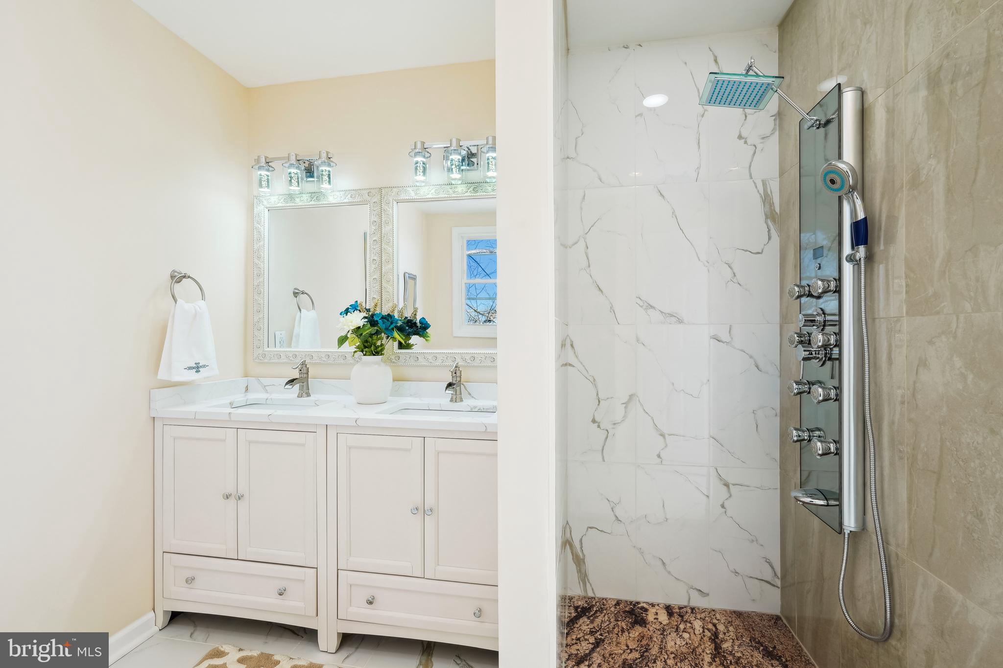 2528 Elvans Road Southeast Washington, DC 20020 - Photo 12 of 31 a bathroom with a sink a mirror and a shower
