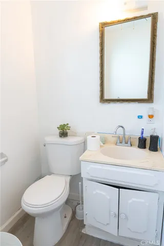 a bathroom with a toilet a sink and a shower curtain