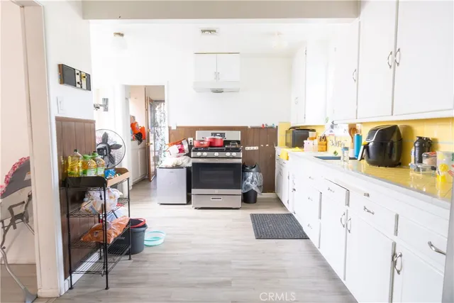 a view of a dining room with furniture and a chandelier