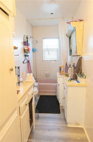 a bathroom with a sink a tub and a mirror