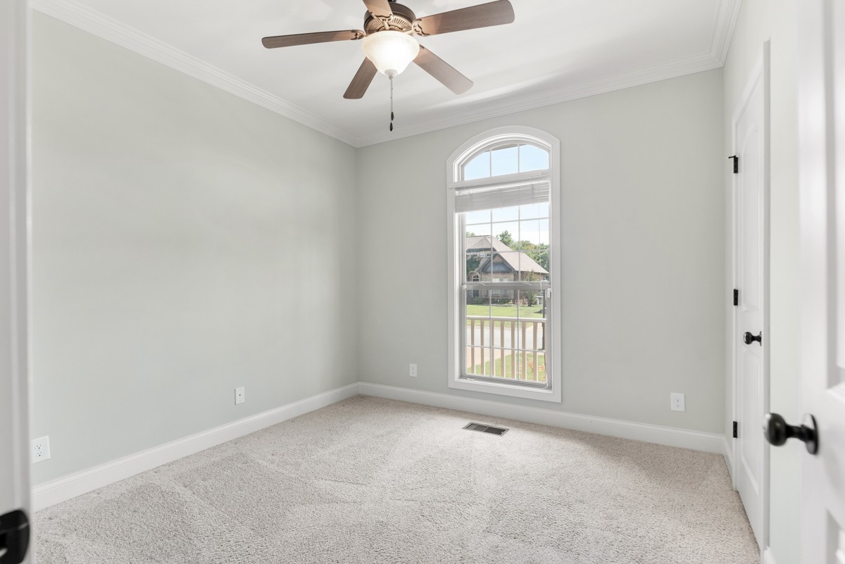 2011 Stonebrook Circle Mount Juliet, TN 37122 - Photo 27 of 39 an empty room with a chandelier fan and windows
