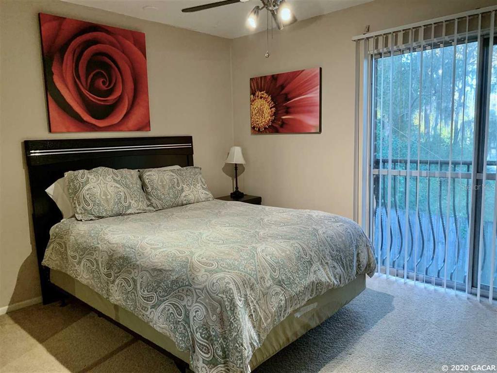 1700 Southwest 16th Court, Unit C26 Gainesville, FL 32608 - Photo 5 of 18 a bedroom with a bed and painting on the wall