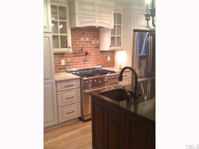7116 Rainwater Road Raleigh, NC 27615 - Photo 3 of 12 Gourmet kitchen with new granite counters, cabinets, & hardware