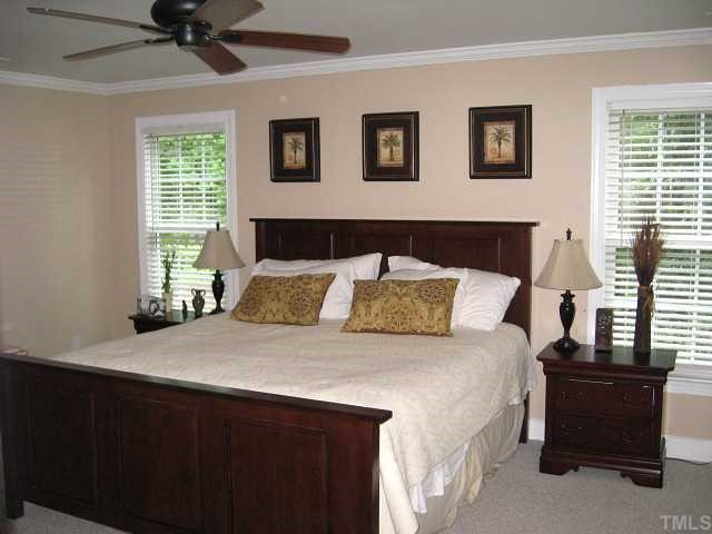 7116 Rainwater Road Raleigh, NC 27615 - Photo 8 of 12 Grand master suite with ceiling fan & walk-in closet with shelving