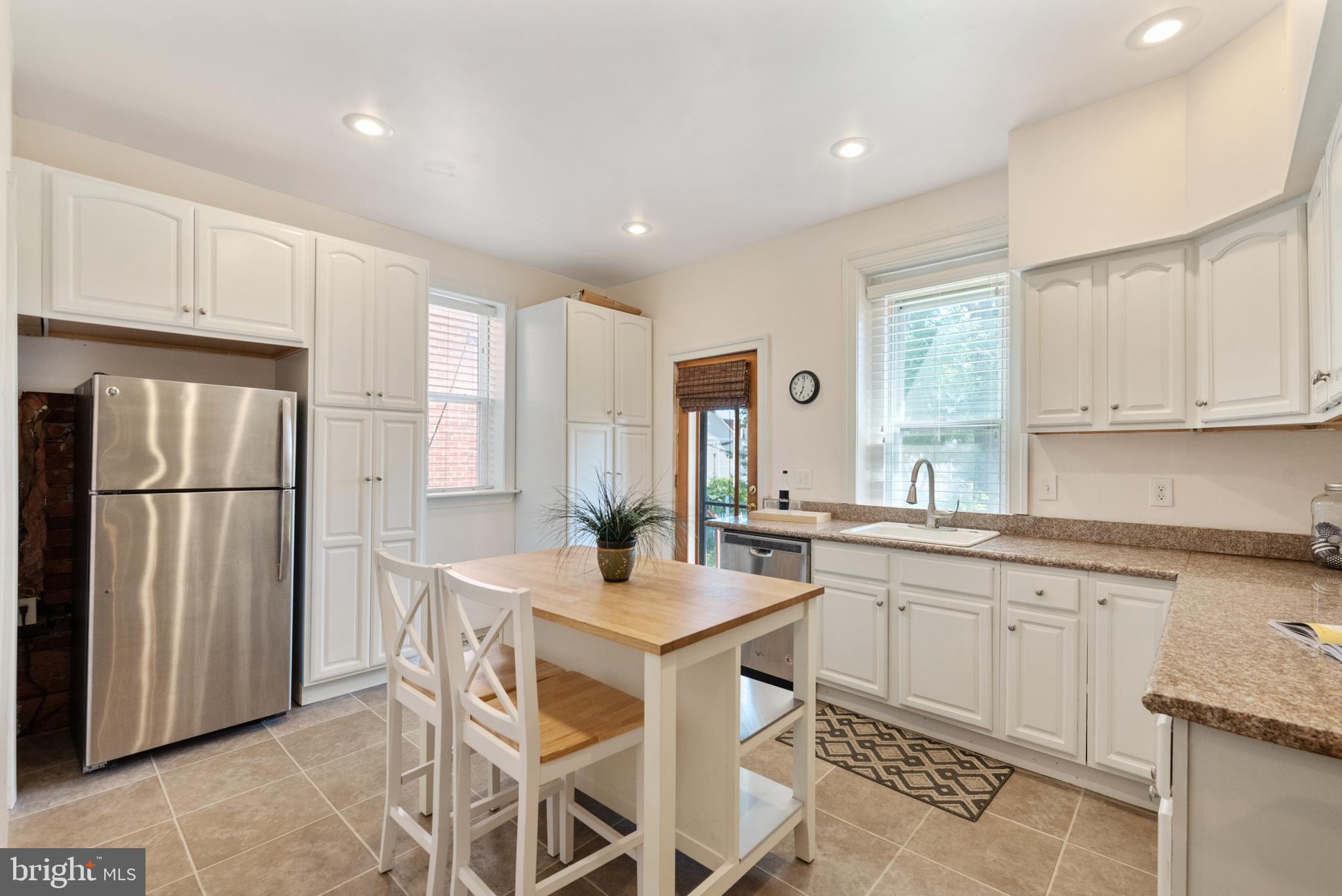 4710 Kingsessing Avenue Philadelphia, PA 19143 - Photo 12 of 30 a kitchen with a sink a refrigerator and white cabinets