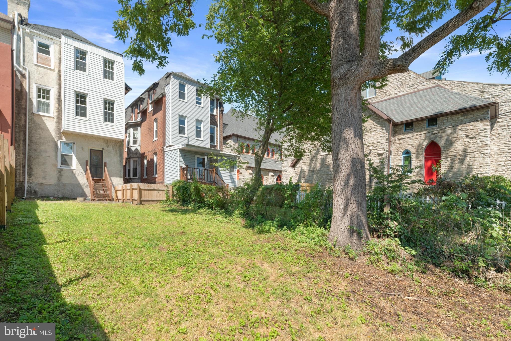 4710 Kingsessing Avenue Philadelphia, PA 19143 - Photo 16 of 30 a view of a white house next to a big yard and large trees