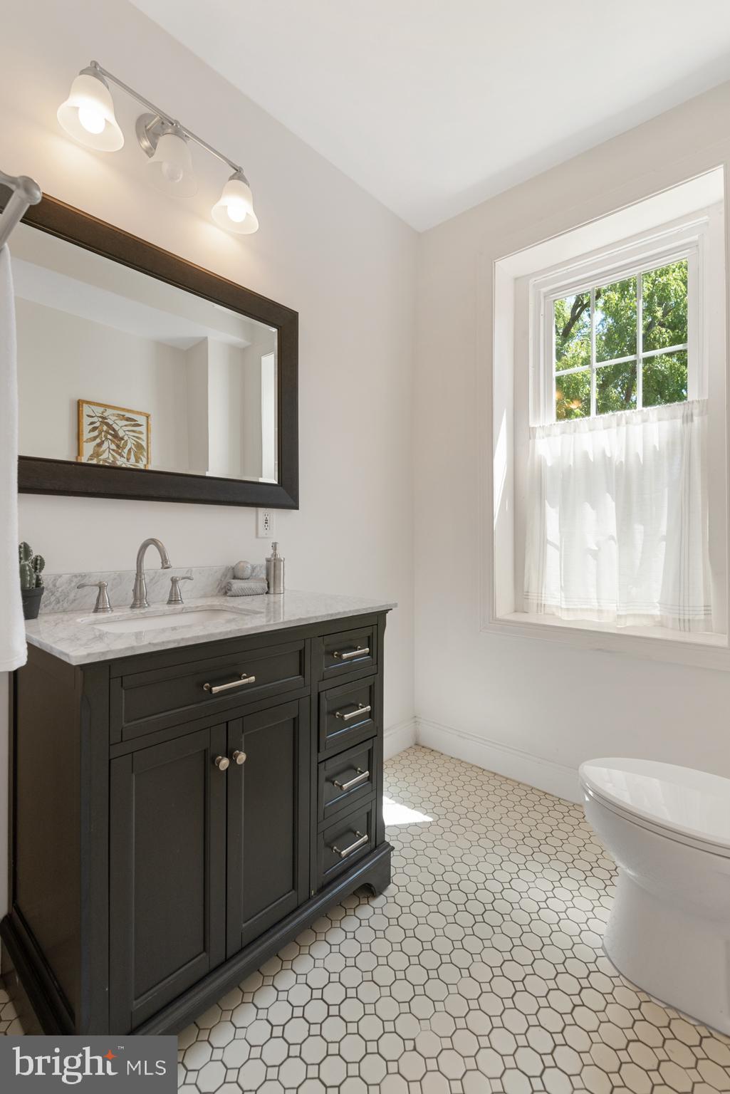 4710 Kingsessing Avenue Philadelphia, PA 19143 - Photo 26 of 30 a bathroom with a sink vanity and a mirror