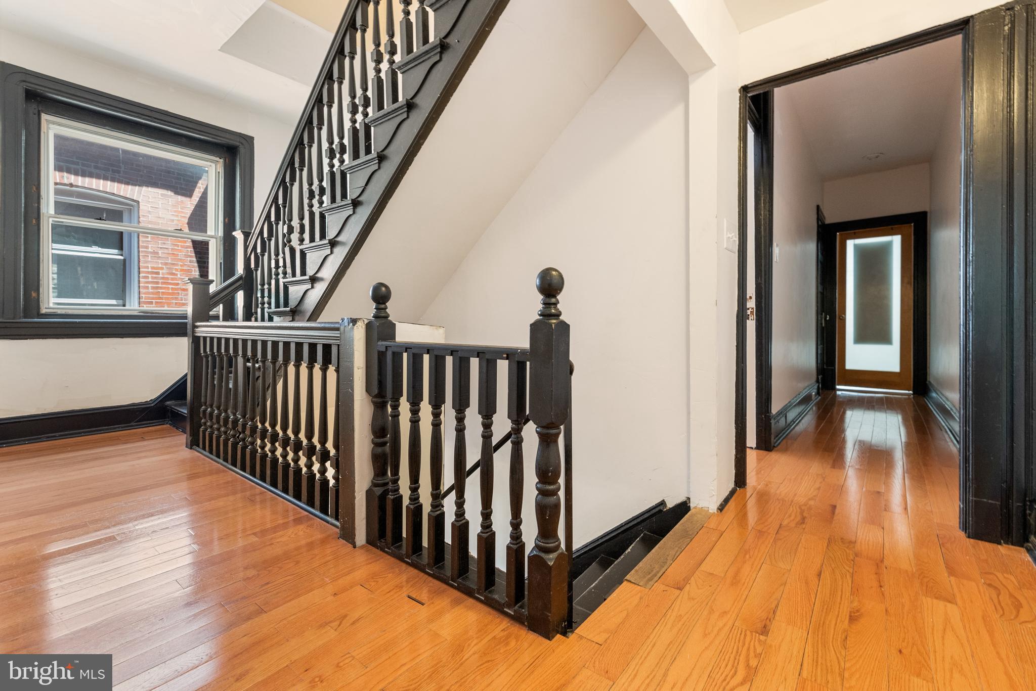 4710 Kingsessing Avenue Philadelphia, PA 19143 - Photo 27 of 30 a view of a hallway with wooden floor and stairs