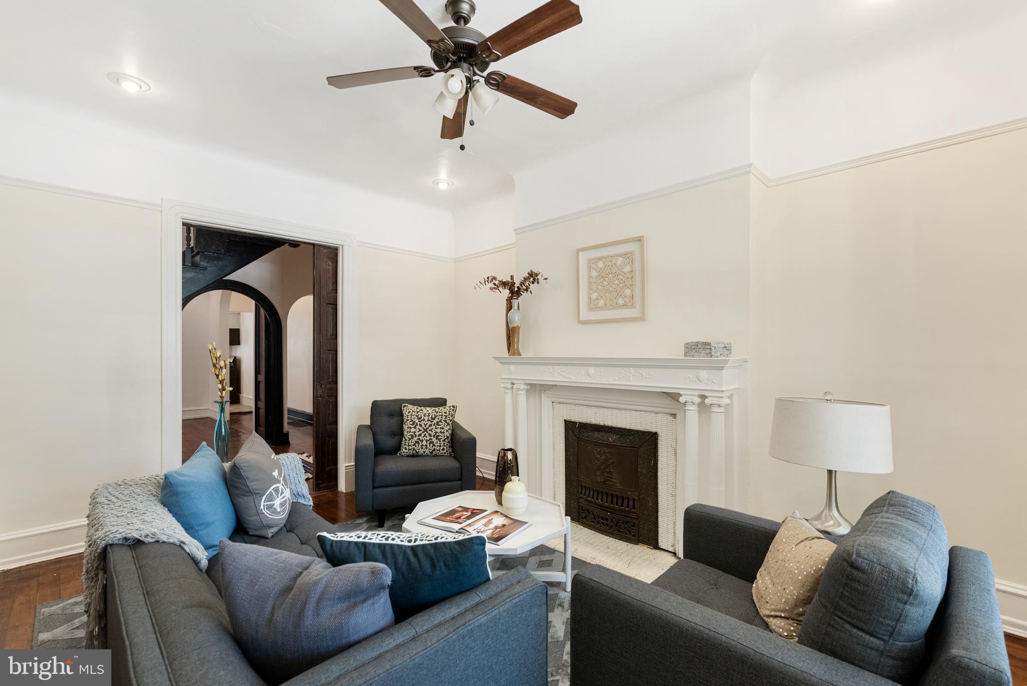 4710 Kingsessing Avenue Philadelphia, PA 19143 - Photo 4 of 30 a living room with furniture and a fireplace
