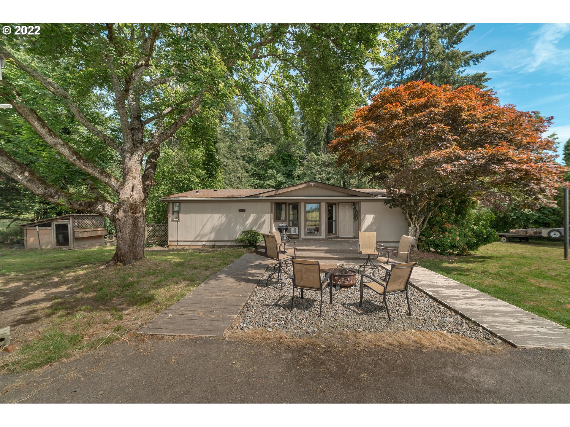 5816 Northwest 304th Street Ridgefield, WA 98642 - Photo 3 of 26 a backyard of a house with table and chairs