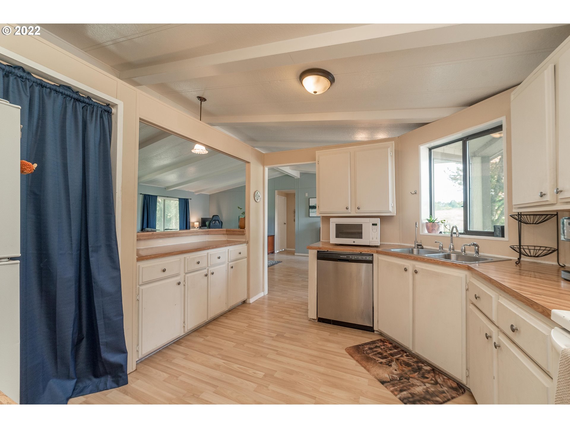 5816 Northwest 304th Street Ridgefield, WA 98642 - Photo 9 of 26 a kitchen with granite countertop a sink stainless steel appliances and cabinets