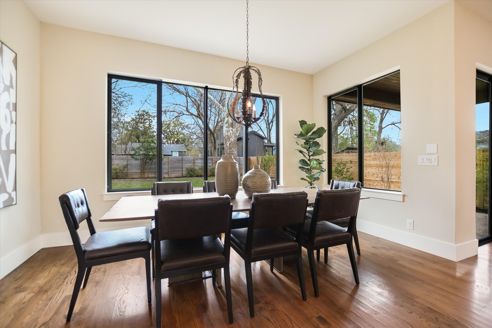 1210 Alguno Road Austin, TX 78757 - Photo 14 of 28 Framed by oversized windows, the dining area feels bright and grounded, with backyard views that make everyday meals feel a little more special.