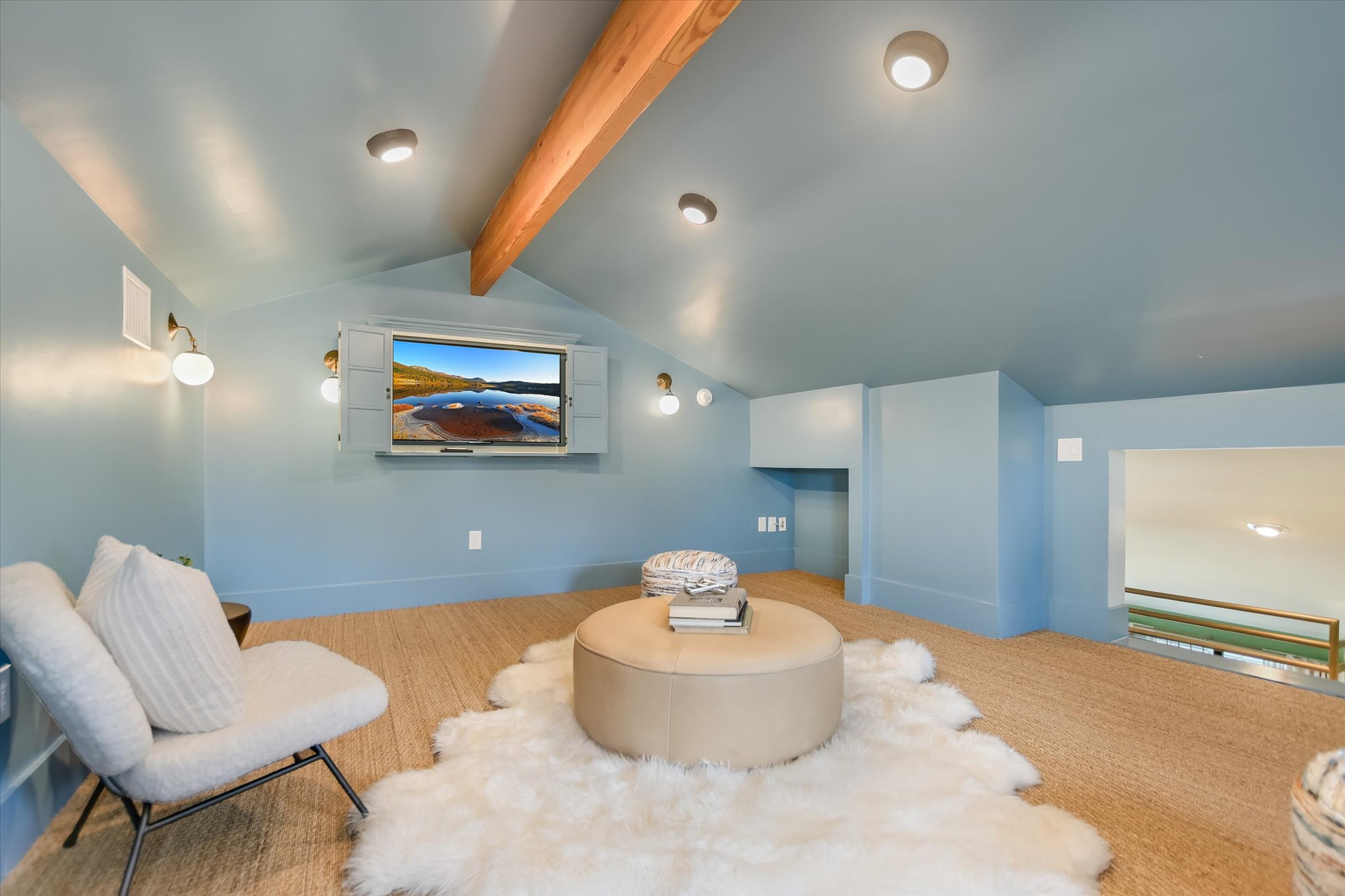 1210 Alguno Road Austin, TX 78757 - Photo 15 of 28 Perched on the second floor, this loft space feels like a little hideaway in the sky. The vaulted, beam-accented ceiling draws your eye up, while the soft blue walls wrap the room in a calm, airy feel that almost mirrors the sky outside.