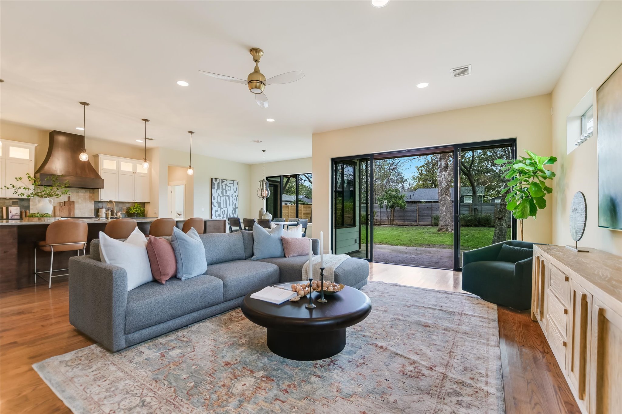 1210 Alguno Road Austin, TX 78757 - Photo 2 of 28 Oversized glass doors draw the eye straight to the backyard, giving the living room an easy indoor-outdoor feel.