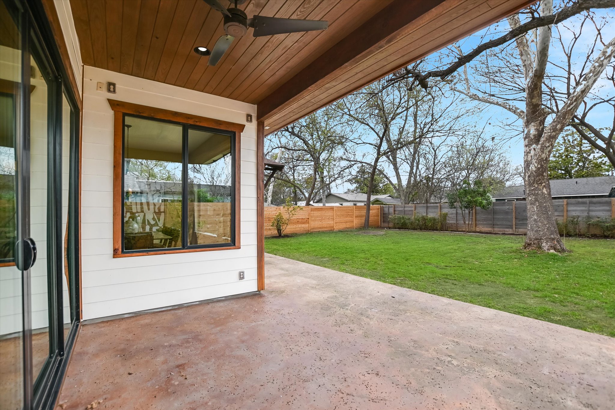 1210 Alguno Road Austin, TX 78757 - Photo 25 of 28 The covered patio extends the living space outdoors, opening to a spacious yard with plenty of room to relax or dine.