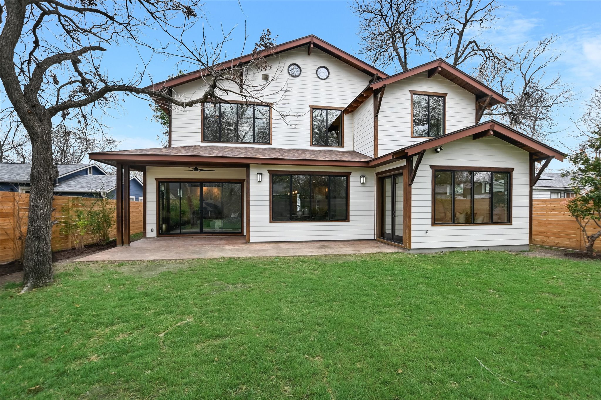 1210 Alguno Road Austin, TX 78757 - Photo 26 of 28 From the back, the home’s custom design really stands out, with clean lines, expansive windows, and a layout that connects beautifully to the yard.