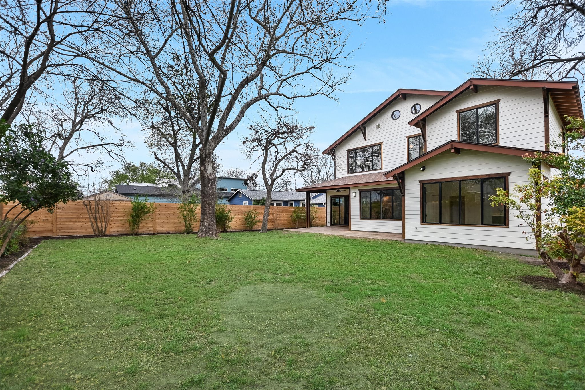 1210 Alguno Road Austin, TX 78757 - Photo 27 of 28 Towering trees and a broad stretch of lawn give the backyard a space, shade, and character that’s hard to find in the heart of the city.