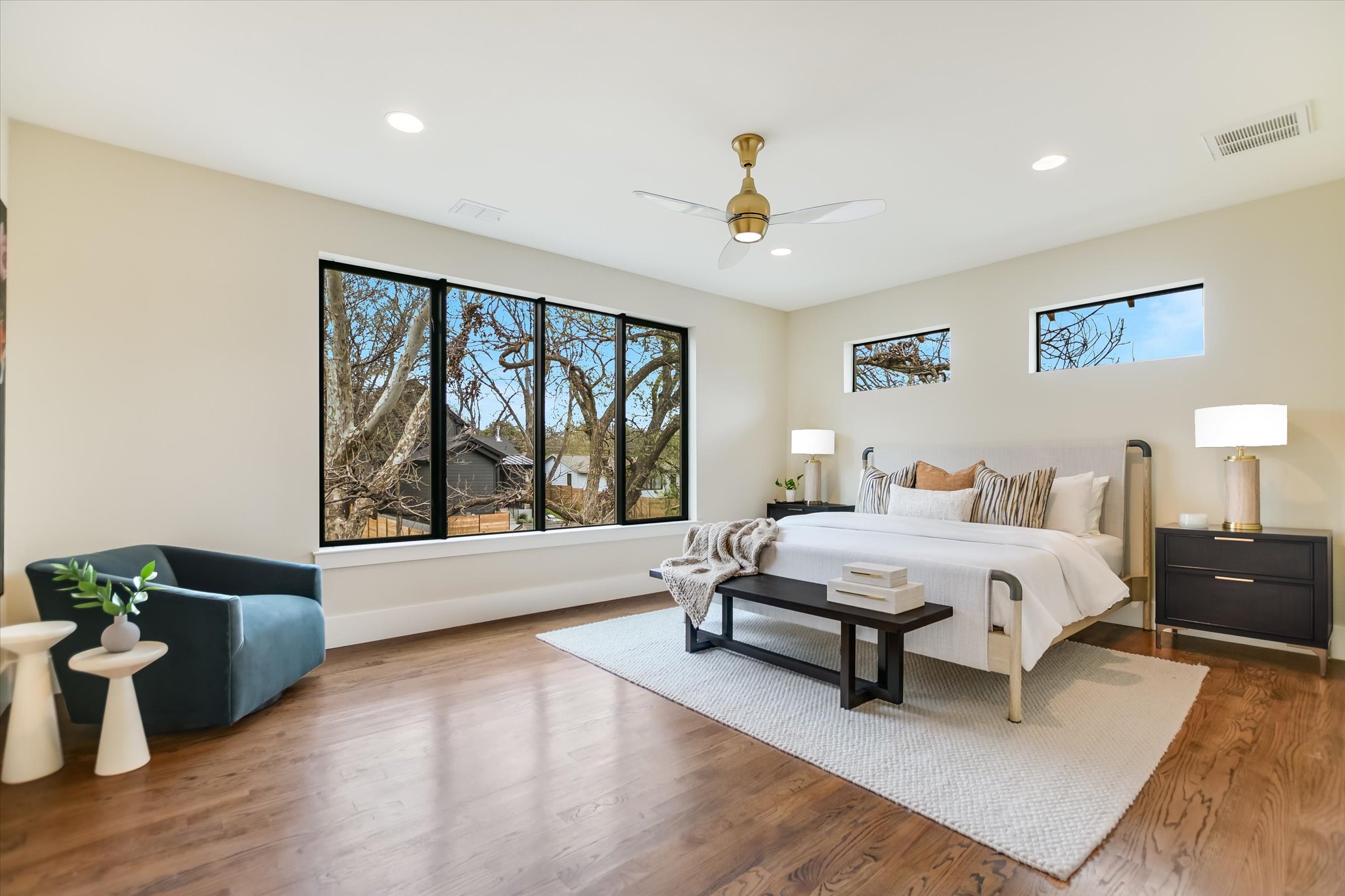 1210 Alguno Road Austin, TX 78757 - Photo 4 of 28 The primary suite is wrapped in windows and set among the trees, it carries the peaceful feeling of a treehouse getaway.