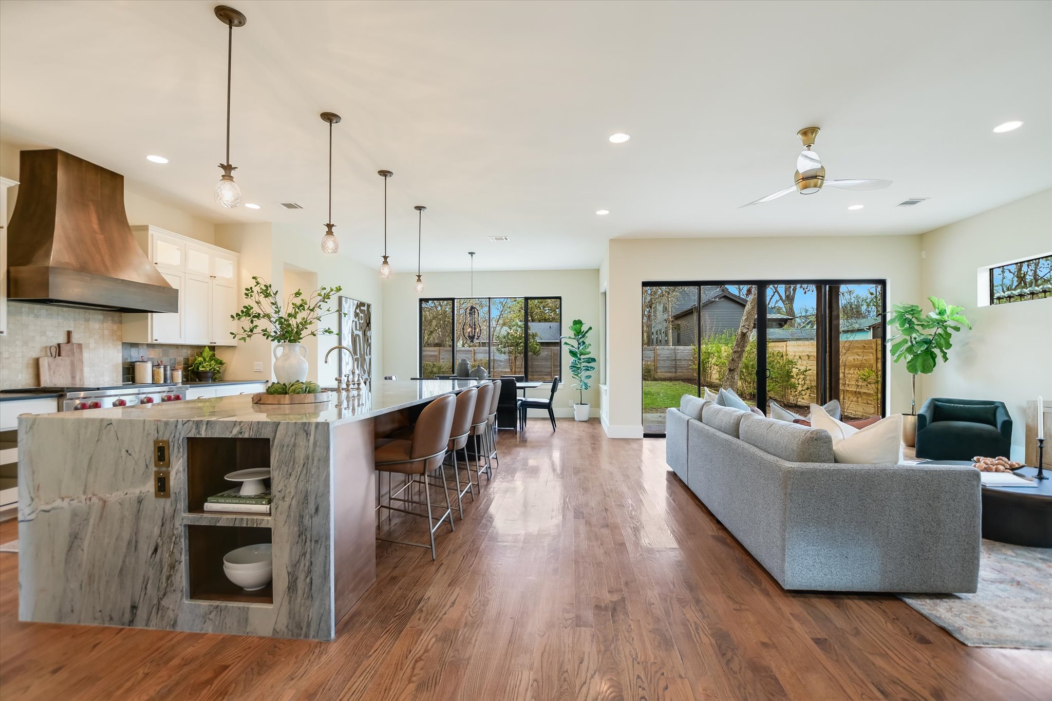 1210 Alguno Road Austin, TX 78757 - Photo 7 of 28 The main living areas unfold in an open concept, grounded by rich oak floors, high ceilings, and display windows that fill the home with natural light.
