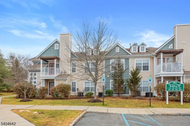 a front view of a residential houses with yard and trees