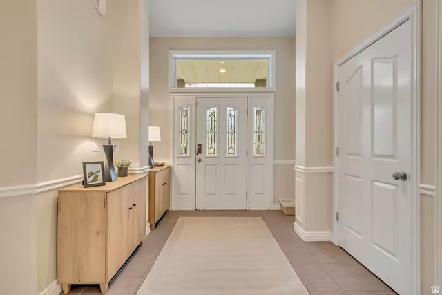 11789 Nicklaus Road Sandy, UT 84092 - Photo 46 of 58 Foyer with light tile patterned floors and baseboards