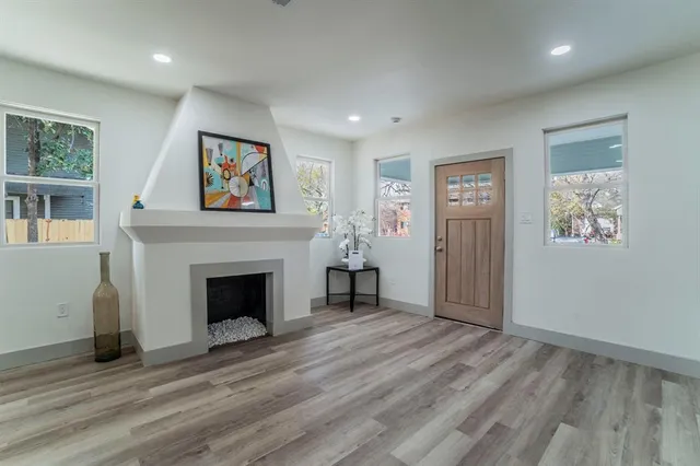 a view of a livingroom with a fireplace and cabinet