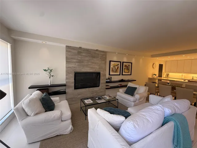 a living room with furniture wooden floor and a fireplace