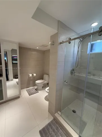 a bathroom with a shower and toilet