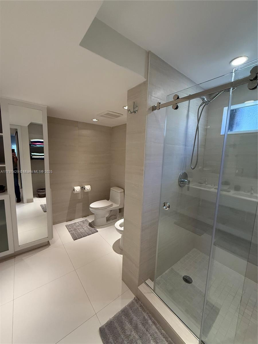 161 Crandon Boulevard, Unit 221 Key Biscayne, FL 33149 - Photo 7 of 13 a bathroom with a shower and toilet