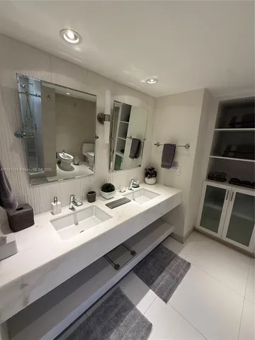 a bathroom with a double vanity sink and mirror