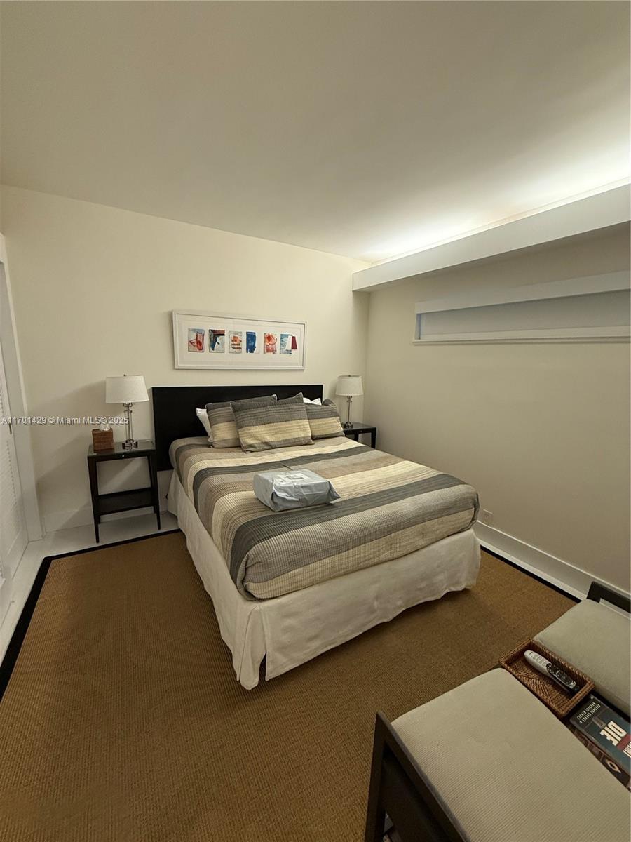 161 Crandon Boulevard, Unit 221 Key Biscayne, FL 33149 - Photo 10 of 13 a bedroom with a bed and a dressers