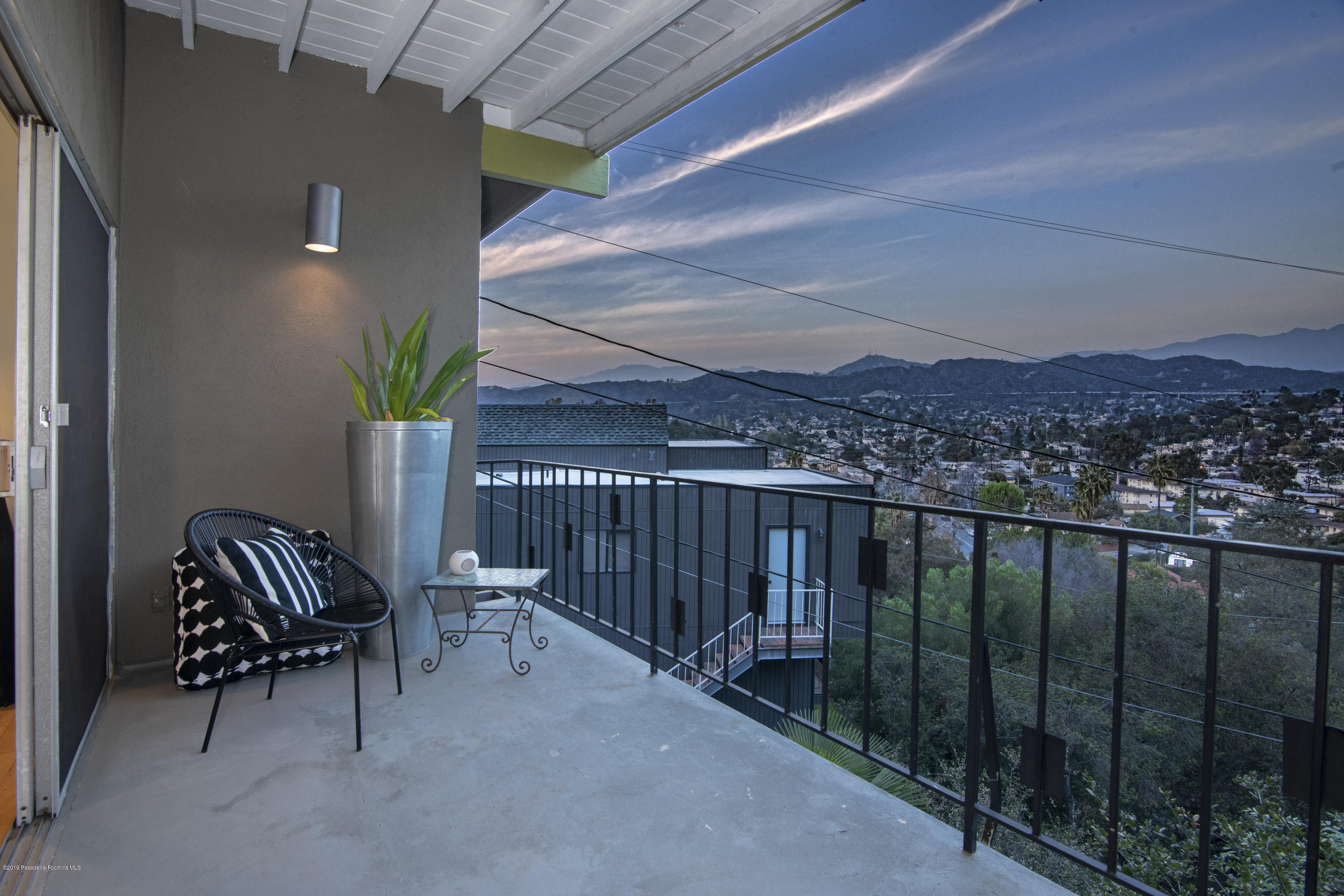 1623 Silverwood Drive Eagle Rock, CA 90041 - Photo 22 of 24 a view of a balcony with chair and a potted plant