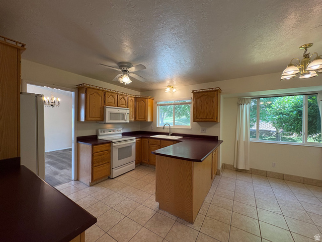 595 Meadowlark Road Orem, UT 84097 - Photo 18 of 87 Kitchen featuring wood cabinetry, white appliances, and a ceiling fan
